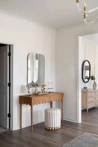 a kitchen with white cabinets and sink