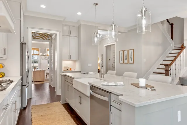 a kitchen with a sink and a stove next to a window