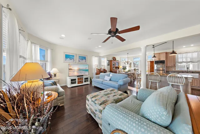 a kitchen with stainless steel appliances granite countertop a sink a stove a dining table and chairs