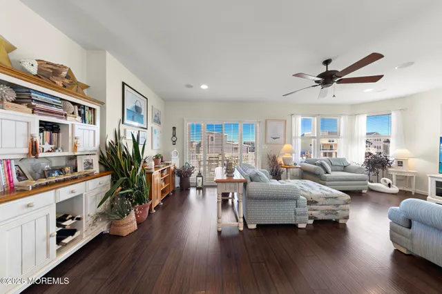 a very nice looking dining room with hardwood floor and a view of living room