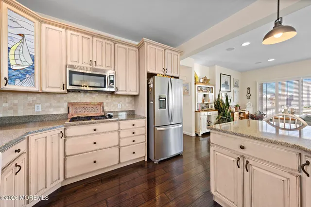 a bedroom with a bed and a flat tv screen on dresser