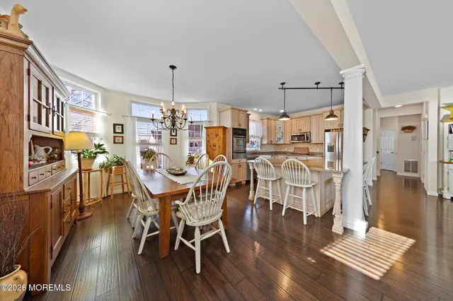 a large kitchen with a table and chairs in it