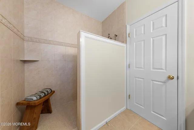a living room with furniture fireplace and a large window