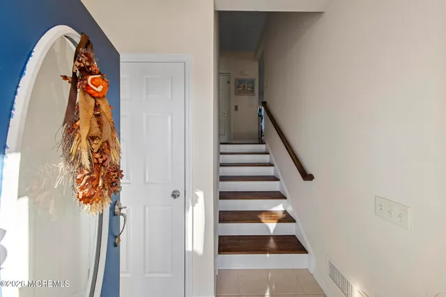 a view of a hallway with furniture and wooden floor