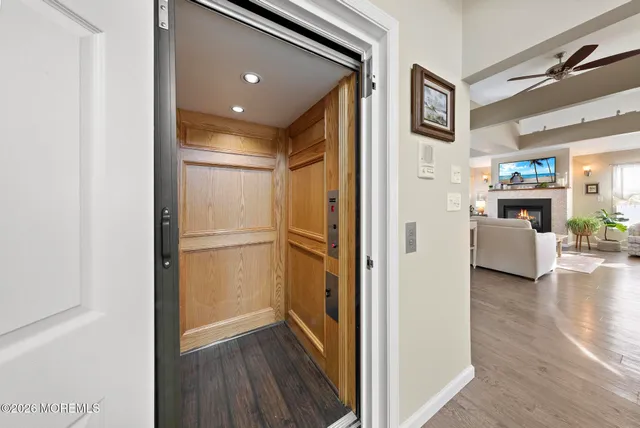 a kitchen with stainless steel appliances granite countertop a refrigerator a stove a sink a dining table and chairs