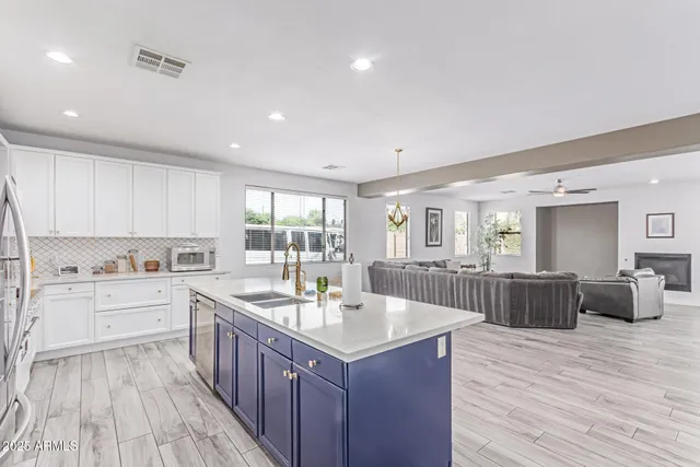 a bedroom with bed and a chandelier