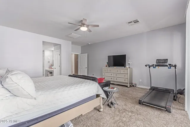 a view of walk in closet with clothes