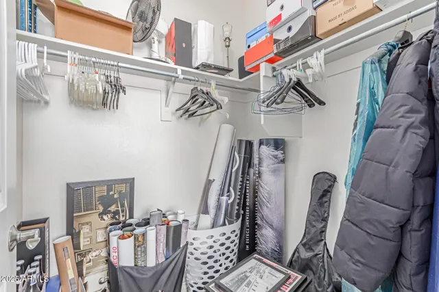 a spacious bedroom with a bed and a window