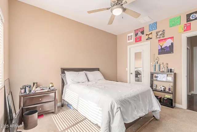 a bathroom with a toilet a sink a mirror a vanity and shower