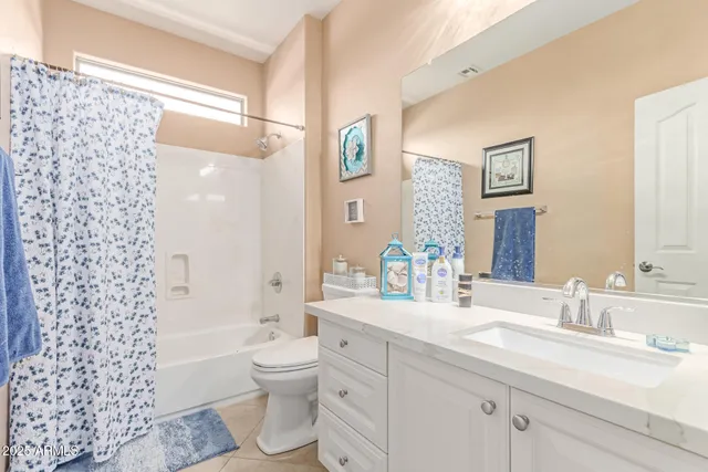 a utility room with fridge dryer and washer
