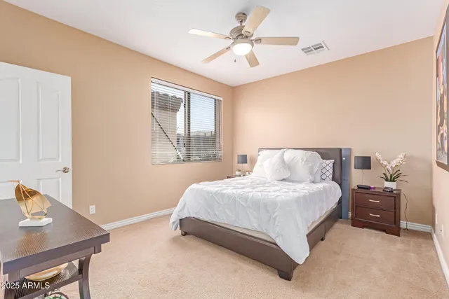 a view of a swimming pool with lawn chairs under an umbrella