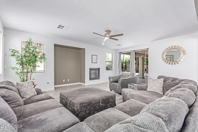 a kitchen with stainless steel appliances granite countertop a kitchen island and chairs in it