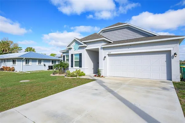 a front view of a house with a garden and yard