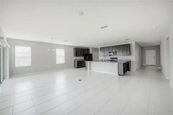 a view of kitchen with stainless steel appliances kitchen island sink refrigerator and stove
