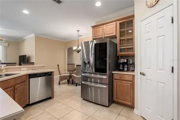 a kitchen with cabinets stainless steel appliances and a sink