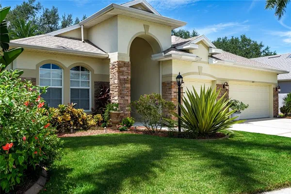 a front view of a house with a garden