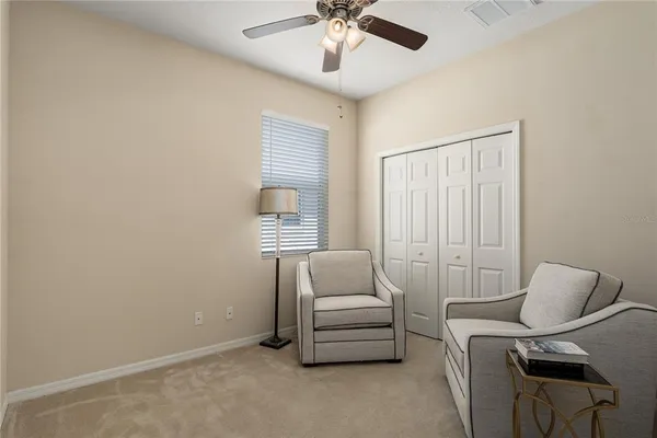 a bedroom with a bed and a wall painting