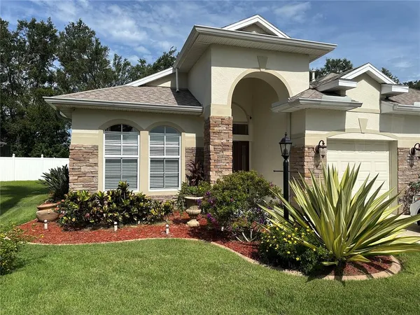 a front view of a house with garden