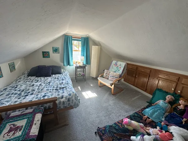 a bedroom with bed and window