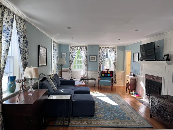 a living room with furniture a fireplace and a flat screen tv