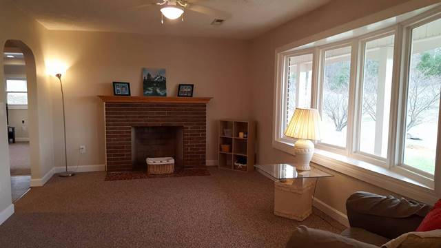 5115 Bethlehem Road Boones Mill, VA 24065 - Photo 11 of 42 a living room with furniture and a fireplace