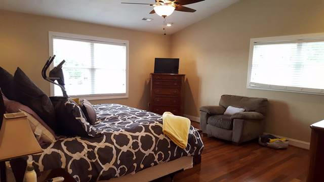 5115 Bethlehem Road Boones Mill, VA 24065 - Photo 17 of 42 a bedroom with a bed and wooden floor
