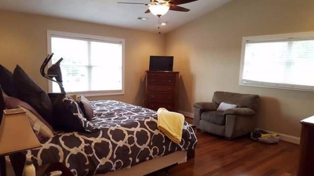 5115 Bethlehem Road Boones Mill, VA 24065 - Photo 21 of 42 a bedroom with a bed and wooden floor