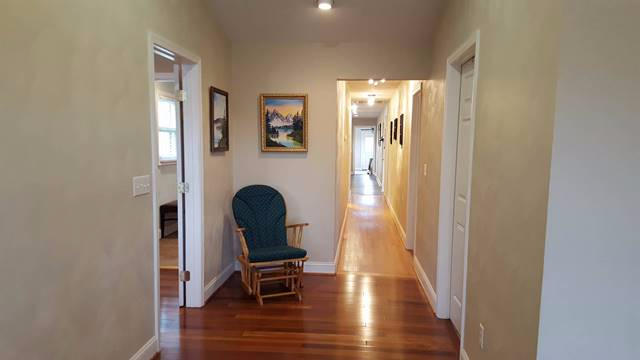 5115 Bethlehem Road Boones Mill, VA 24065 - Photo 24 of 42 a view of a hallway with wooden floor and furniture