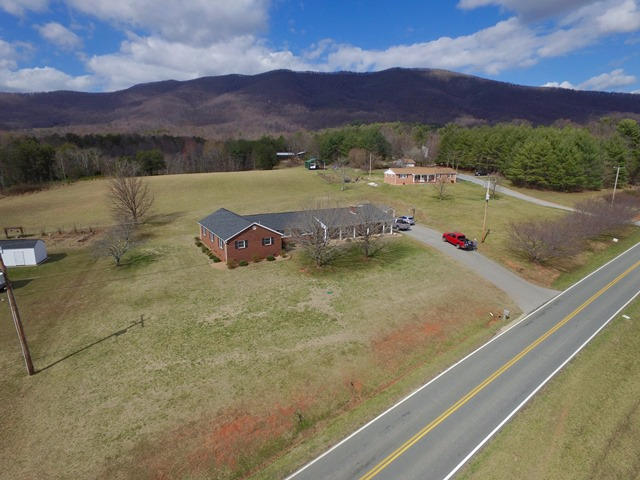 5115 Bethlehem Road Boones Mill, VA 24065 - Photo 42 of 42 a view of a lush green hillside and a houses