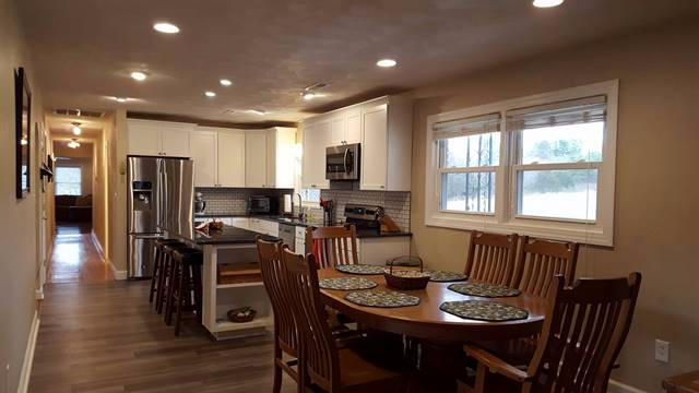 5115 Bethlehem Road Boones Mill, VA 24065 - Photo 7 of 42 a view of a dining room with furniture a rug and wooden floor