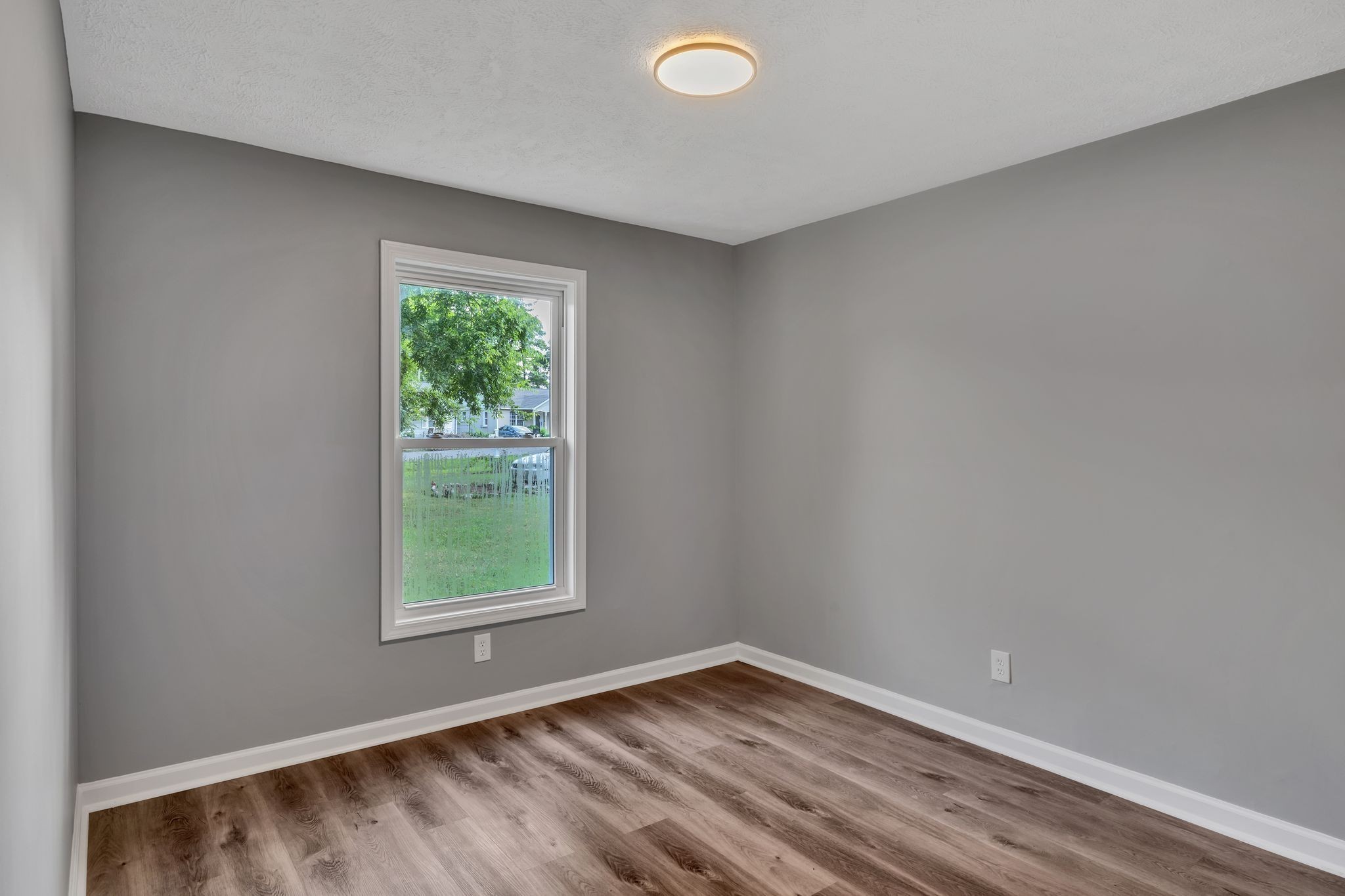 302 Maple Street Madison, TN 37115 - Photo 16 of 33 a view of an empty room with wooden floor and a window