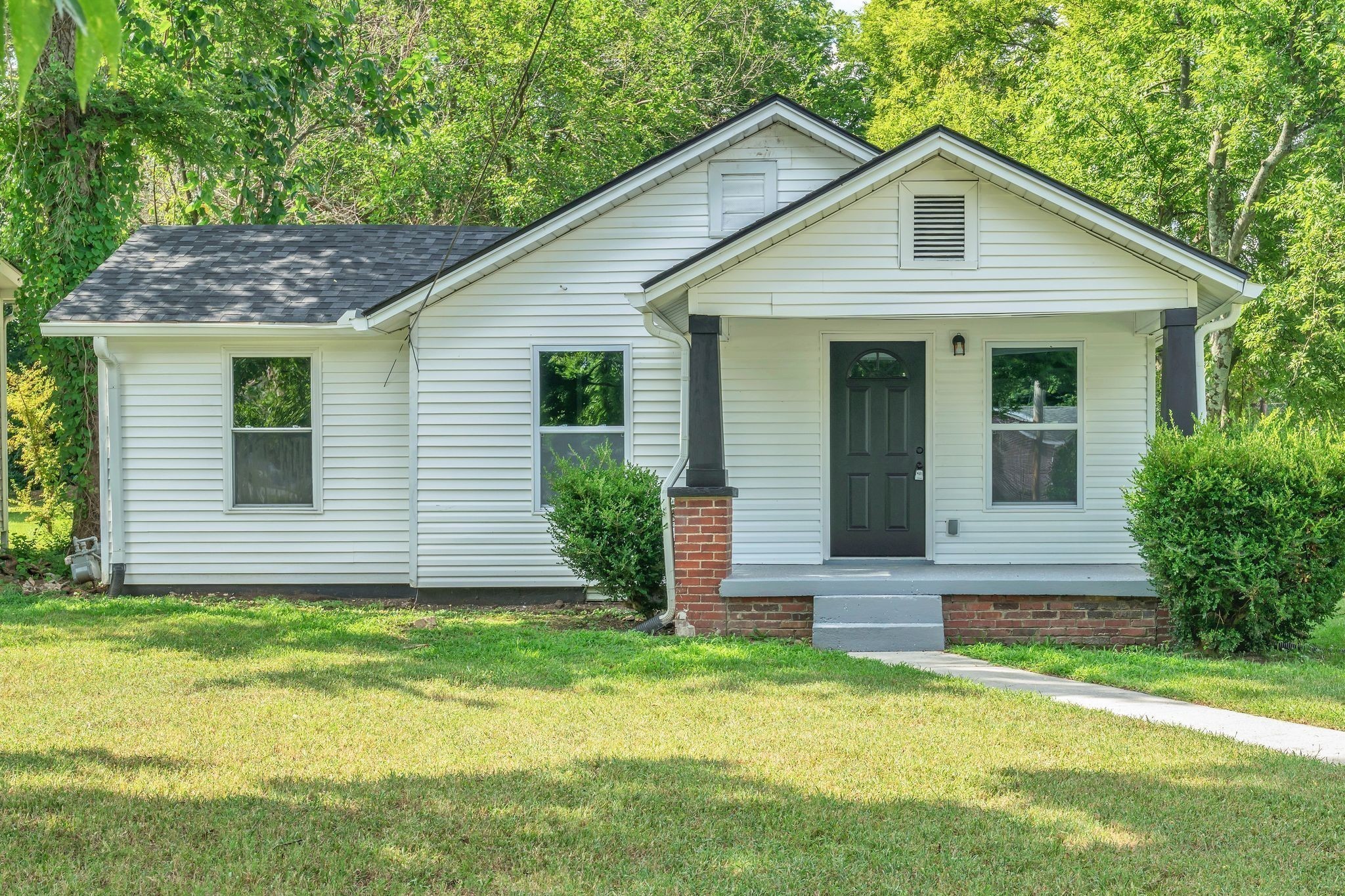 302 Maple Street Madison, TN 37115 - Photo 2 of 33 a front view of a house with a yard and garage