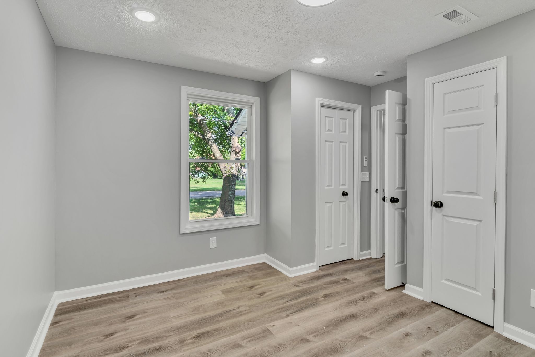 302 Maple Street Madison, TN 37115 - Photo 23 of 33 a view of an empty room with wooden floor and a window