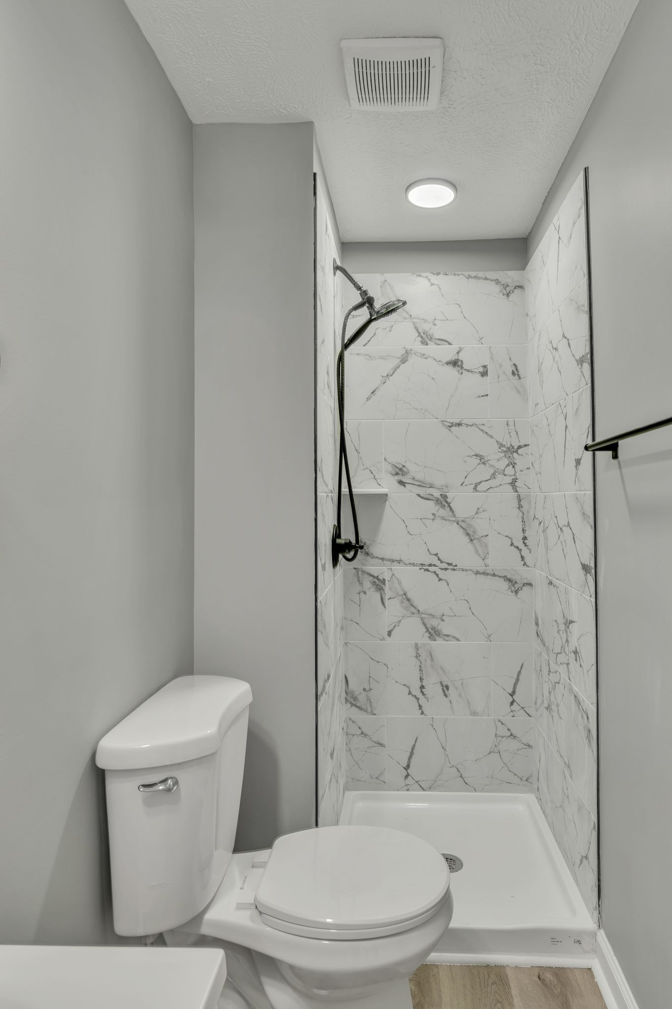 302 Maple Street Madison, TN 37115 - Photo 25 of 33 a white toilet sitting next to a bath tub and a shower