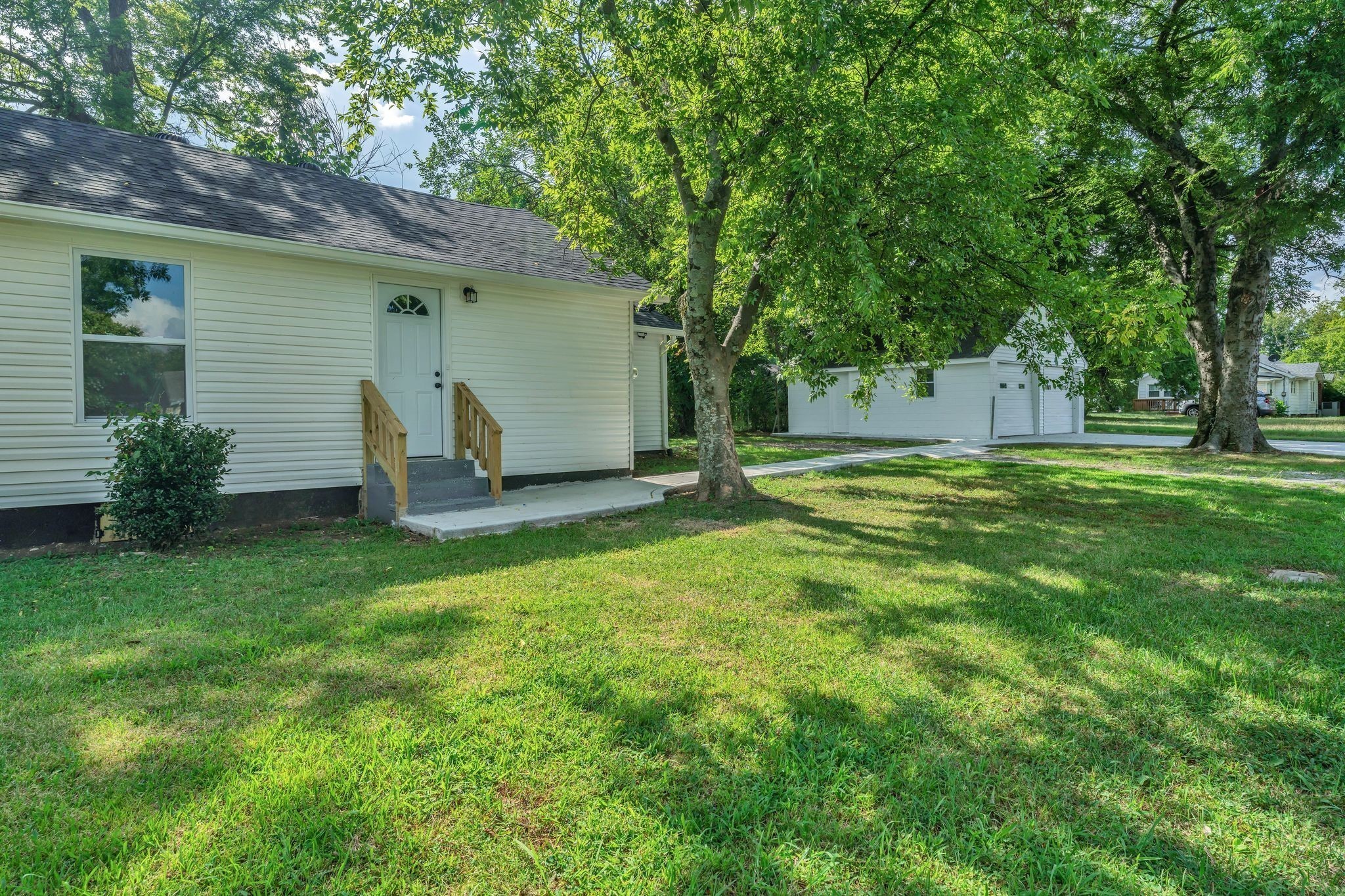 302 Maple Street Madison, TN 37115 - Photo 28 of 33 a view of a backyard with a garden and entertaining space