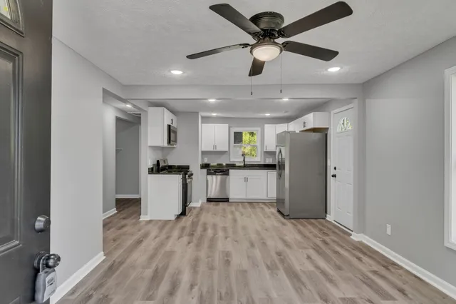 a kitchen with stainless steel appliances kitchen island a refrigerator and a stove top oven