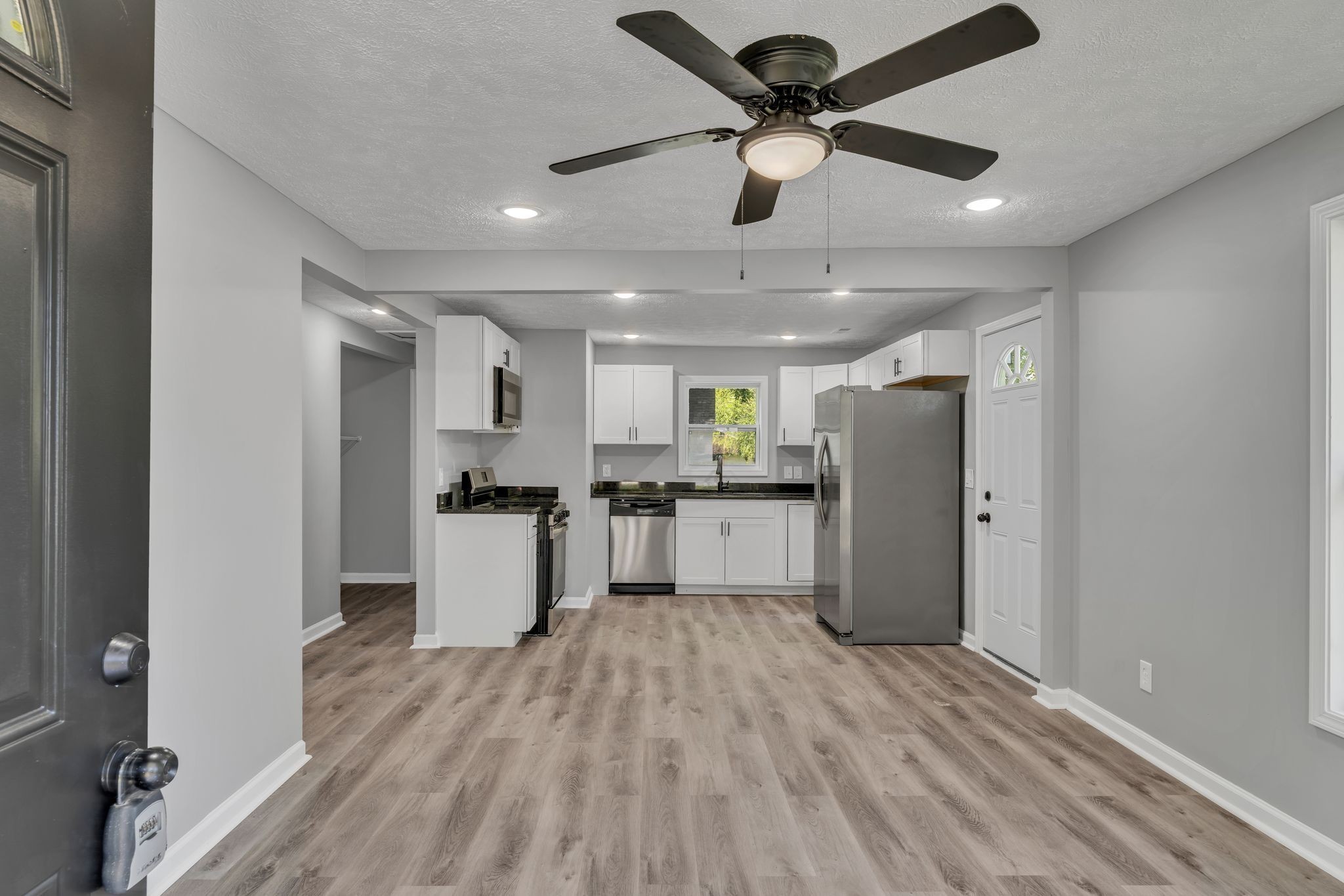 302 Maple Street Madison, TN 37115 - Photo 7 of 33 a kitchen with stainless steel appliances kitchen island a refrigerator and a stove top oven