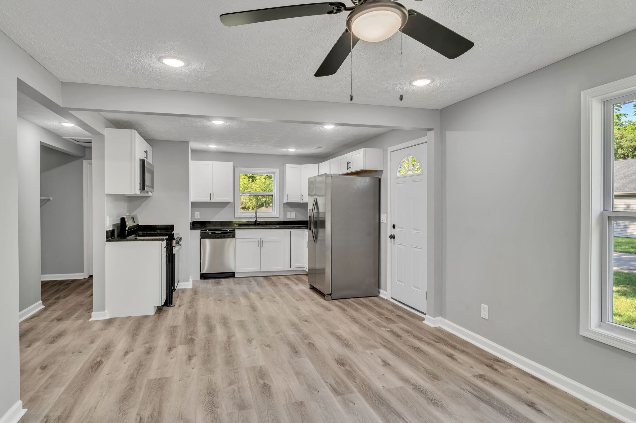 302 Maple Street Madison, TN 37115 - Photo 8 of 33 a kitchen with refrigerator cabinets and wooden floor