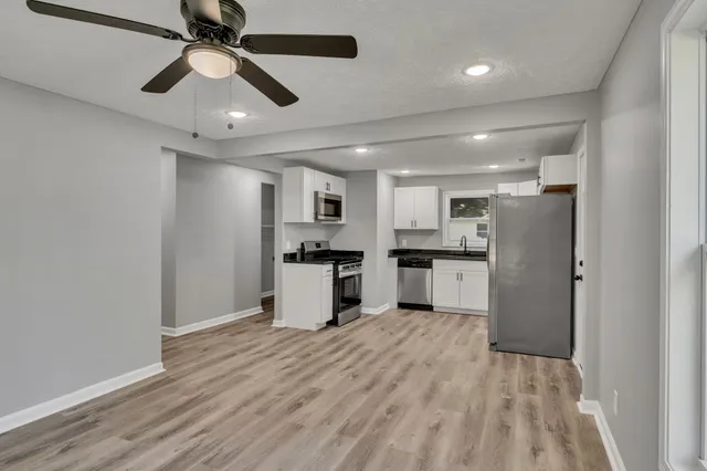 a view of kitchen with refrigerator microwave and wooden floor