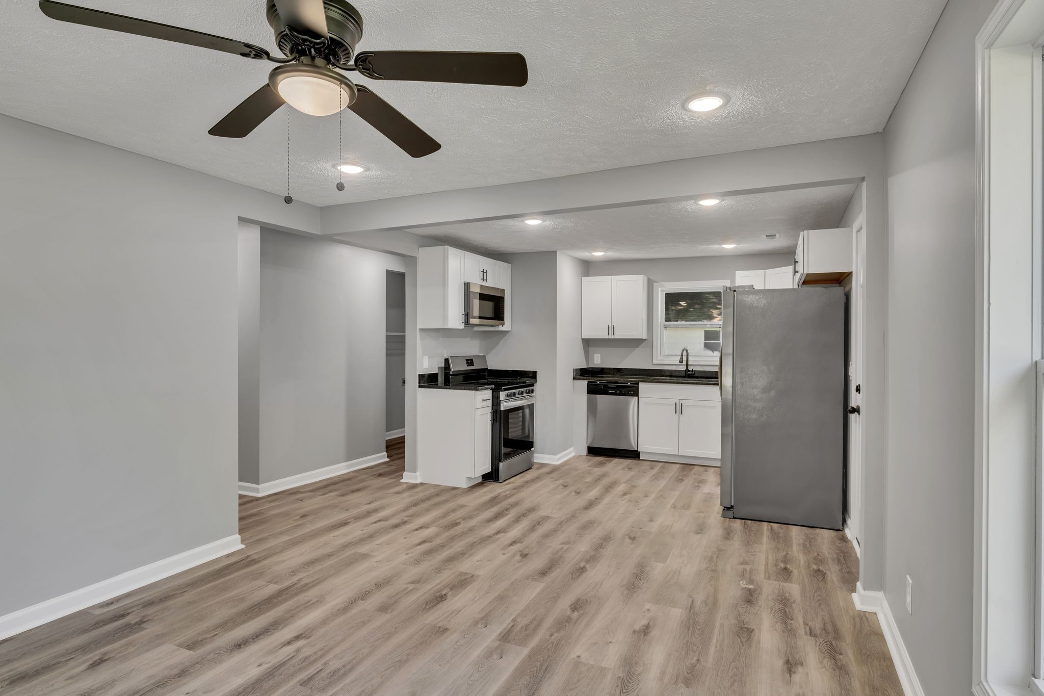 302 Maple Street Madison, TN 37115 - Photo 9 of 33 a view of kitchen with refrigerator microwave and wooden floor