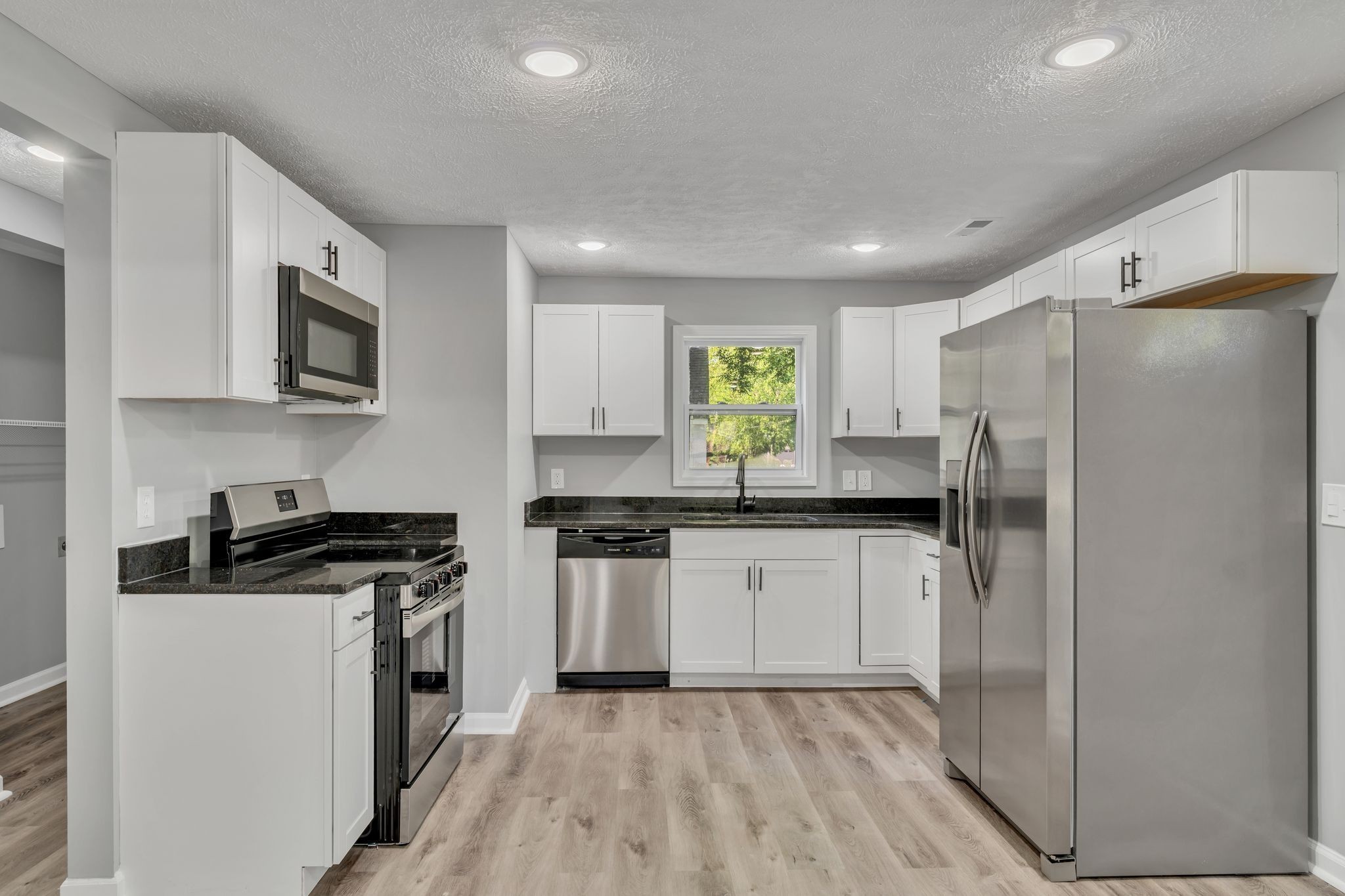 302 Maple Street Madison, TN 37115 - Photo 10 of 33 a kitchen with a refrigerator a stove top oven a sink and dishwasher