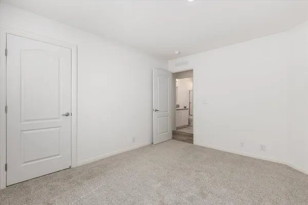 a bathroom with washing machine and cabinets