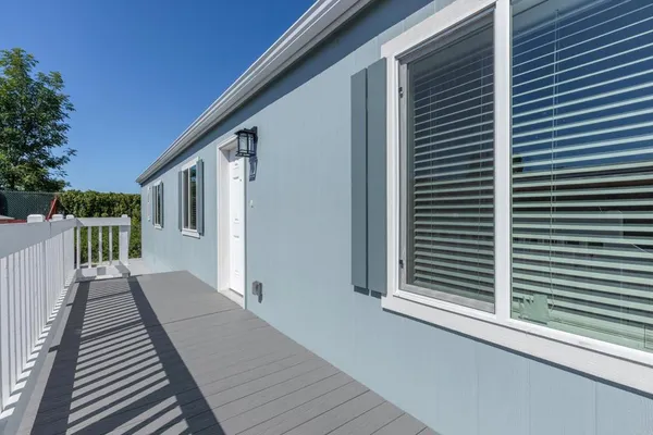 a backyard of a house with table and chairs