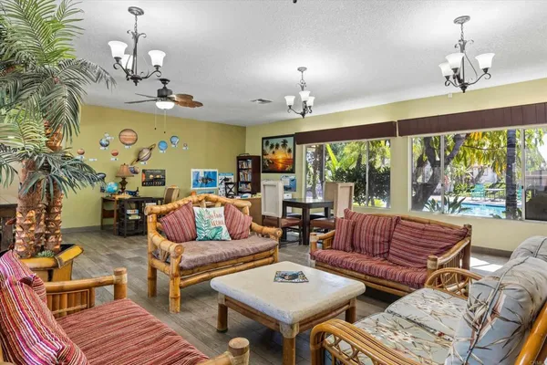 a living room with furniture and a book shelf