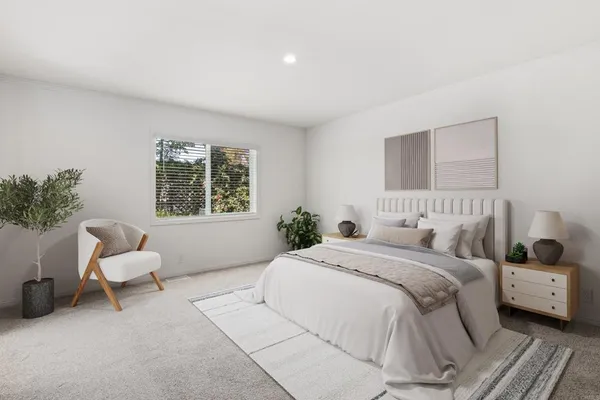 a bedroom with a bed and a couch