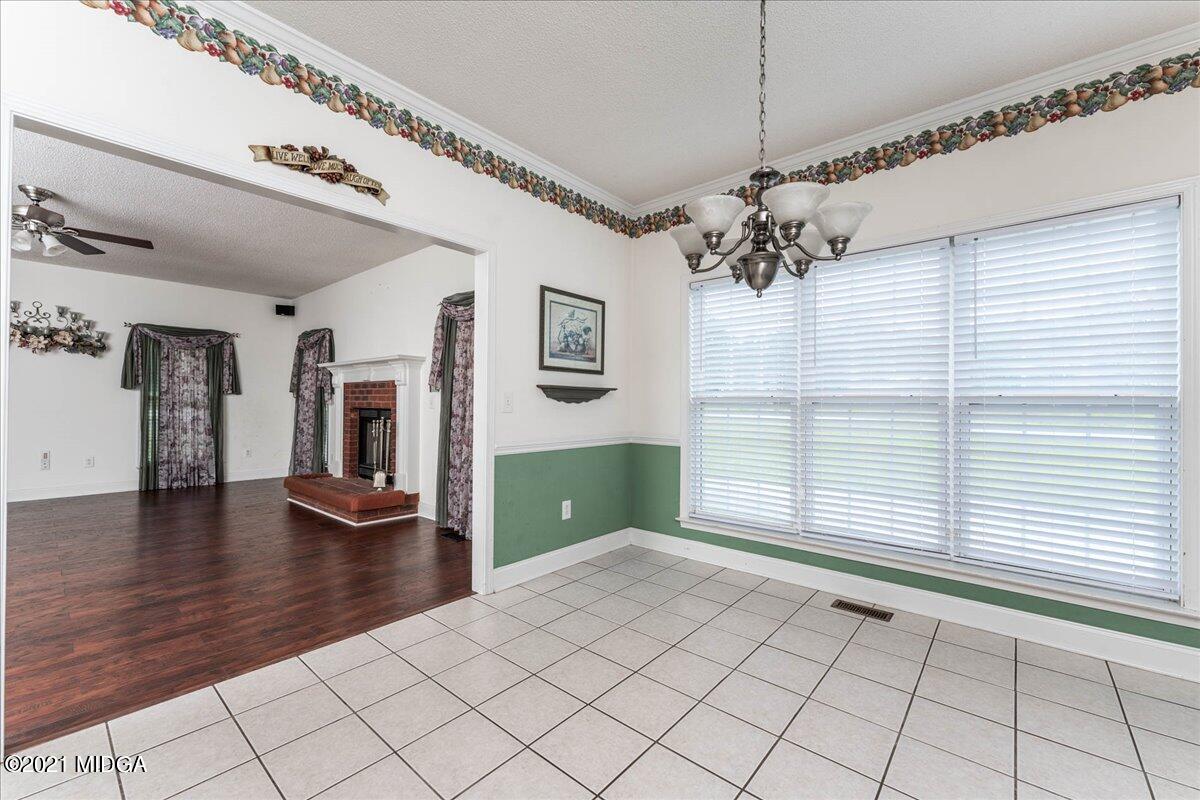 7455 Columbus Road Lizella, GA 31052 - Photo 11 of 32 a view of a livingroom with a ceiling fan and window