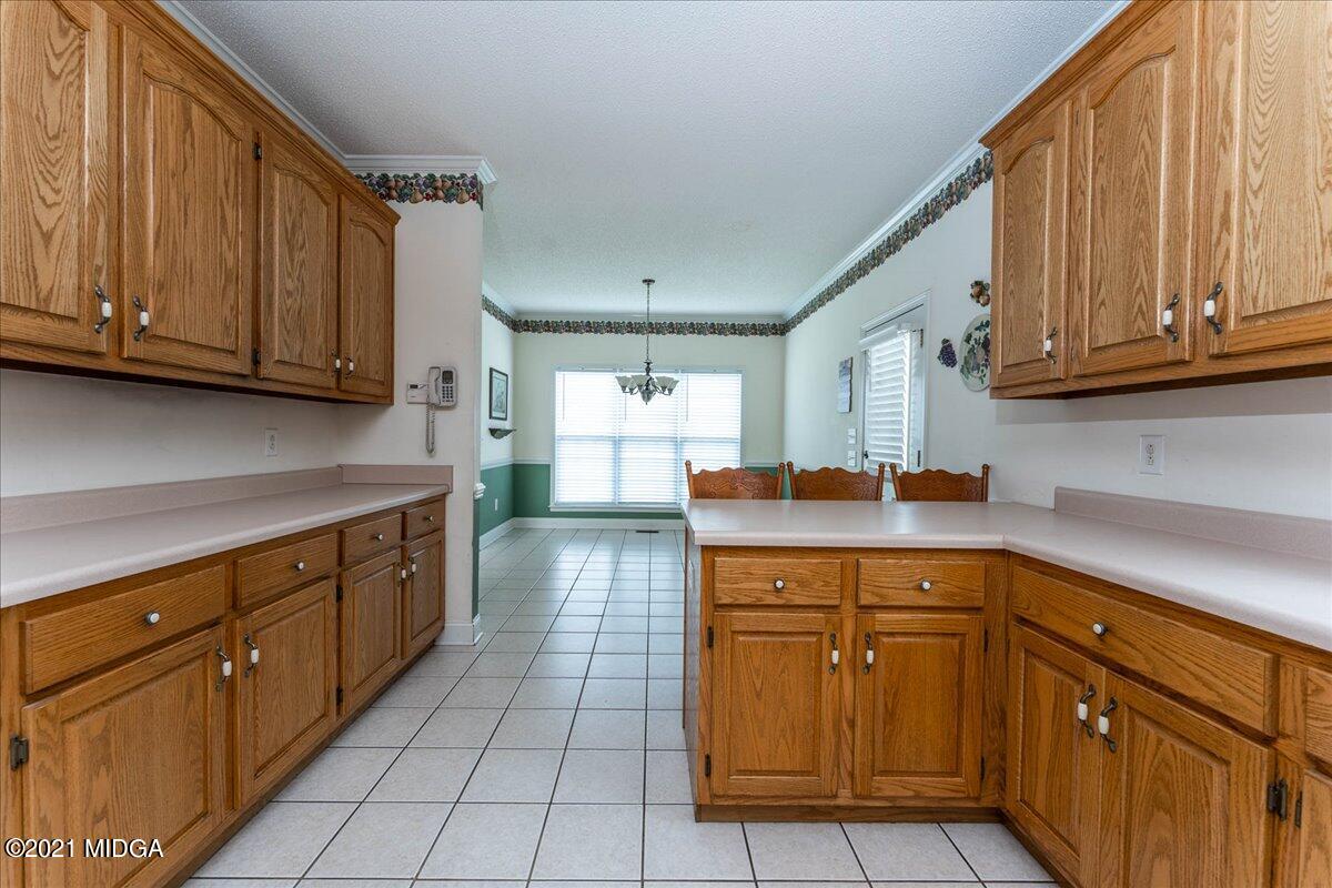 7455 Columbus Road Lizella, GA 31052 - Photo 16 of 32 a kitchen with stainless steel appliances granite countertop a sink and cabinets