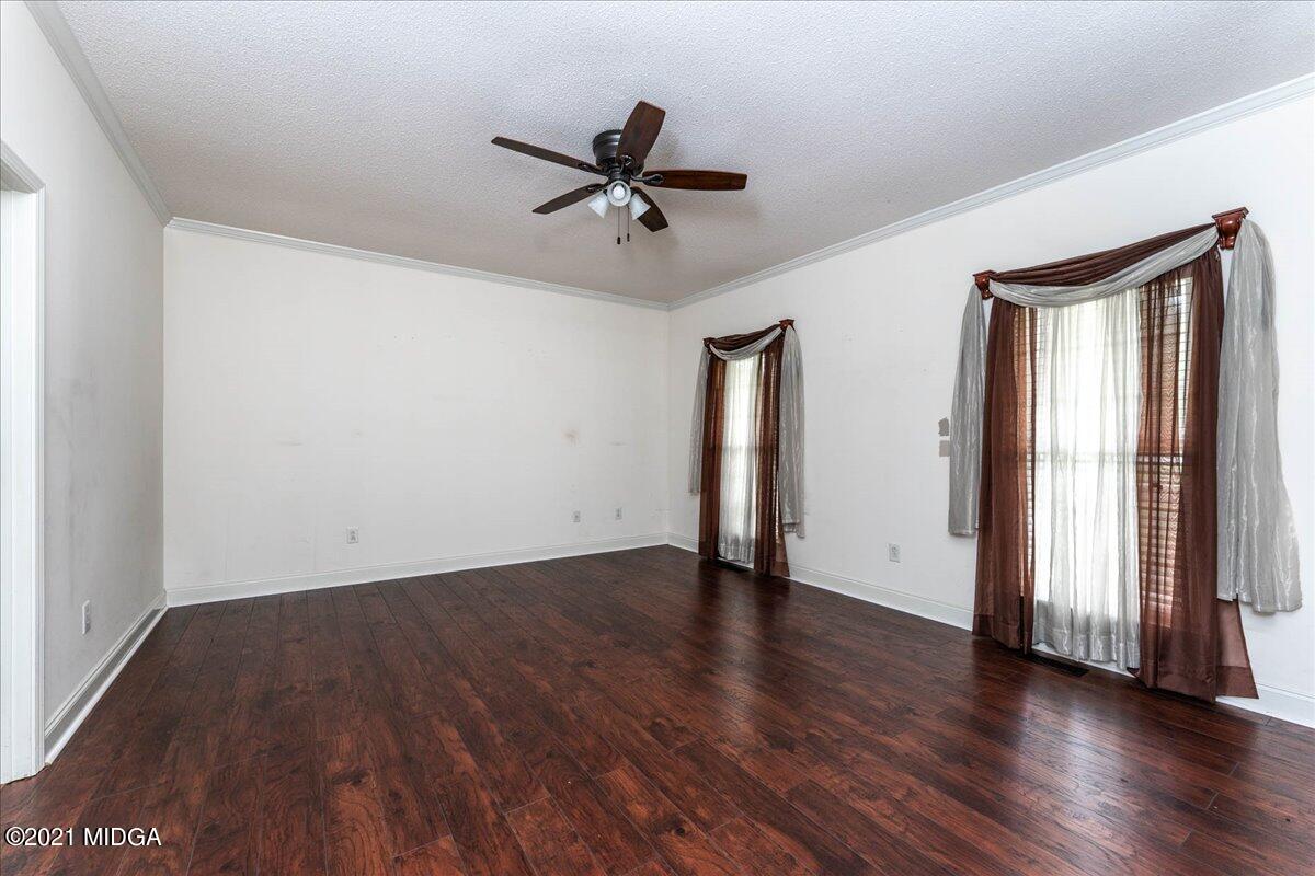 7455 Columbus Road Lizella, GA 31052 - Photo 19 of 32 an empty room with wooden floor and windows