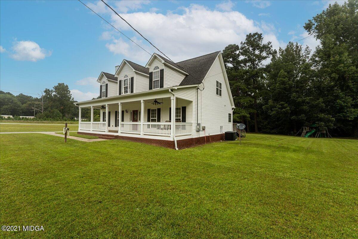7455 Columbus Road Lizella, GA 31052 - Photo 3 of 32 a view of a house with a backyard