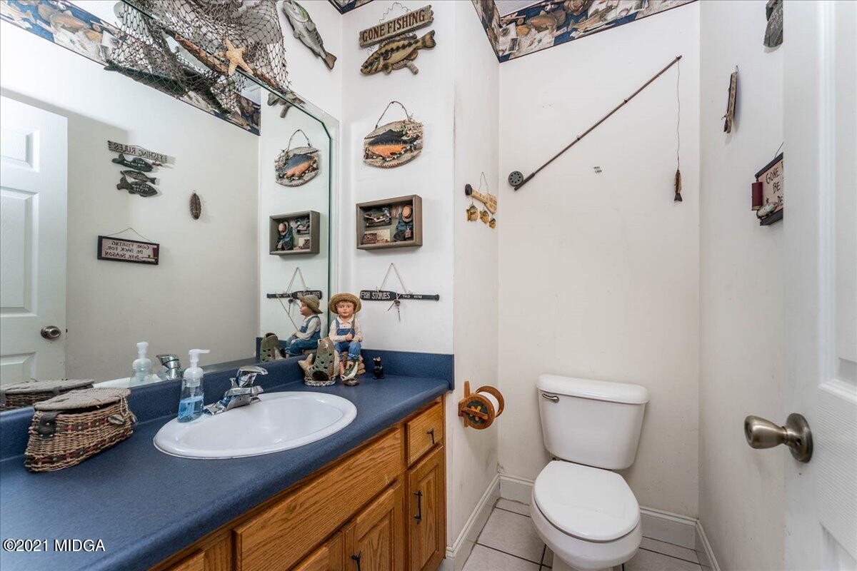 7455 Columbus Road Lizella, GA 31052 - Photo 23 of 32 a bathroom with a sink mirror vanity and toilet
